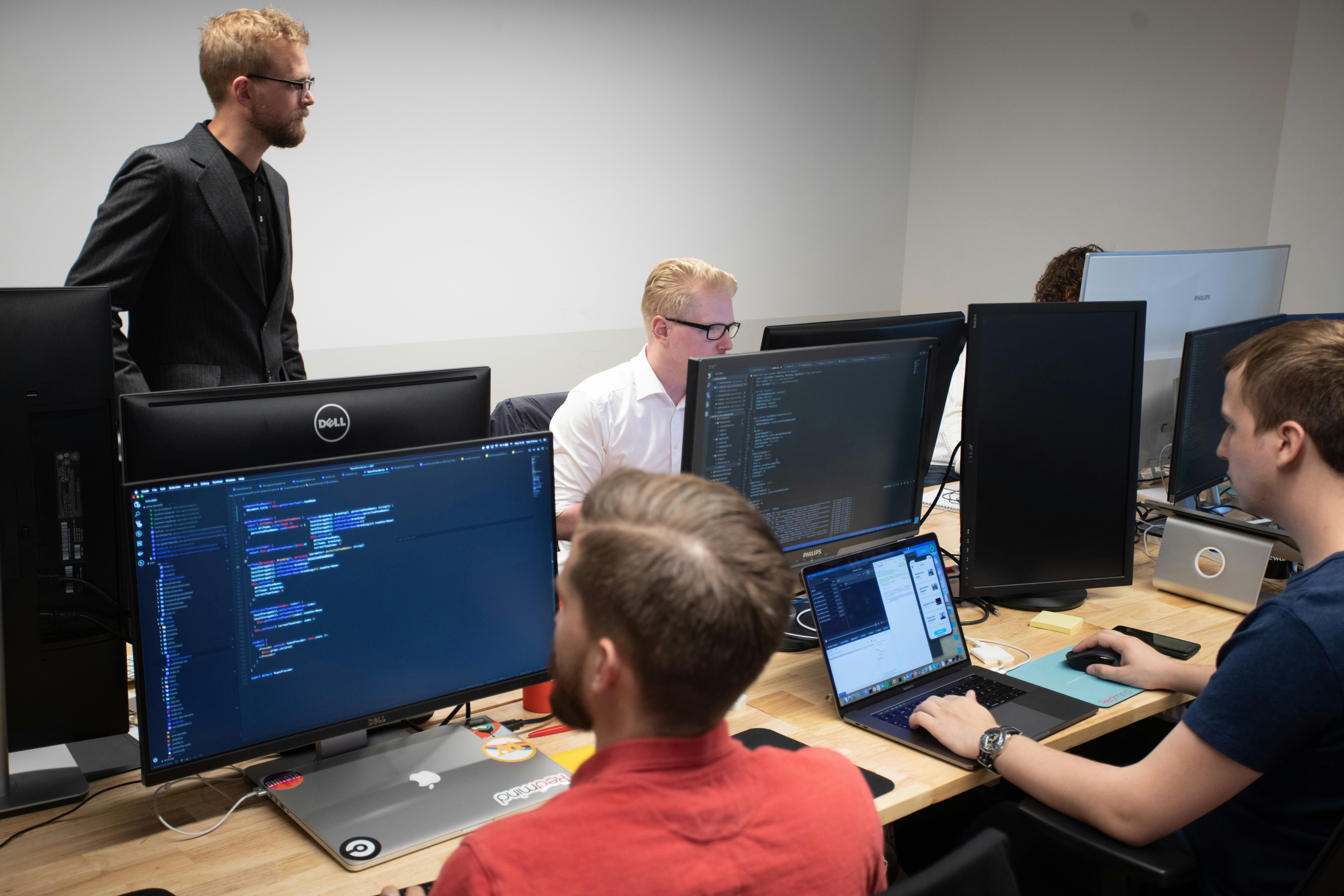 Group of programmers in a room collaborating